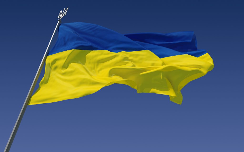 Ukraine flag in blue and yellow flying in the wind.