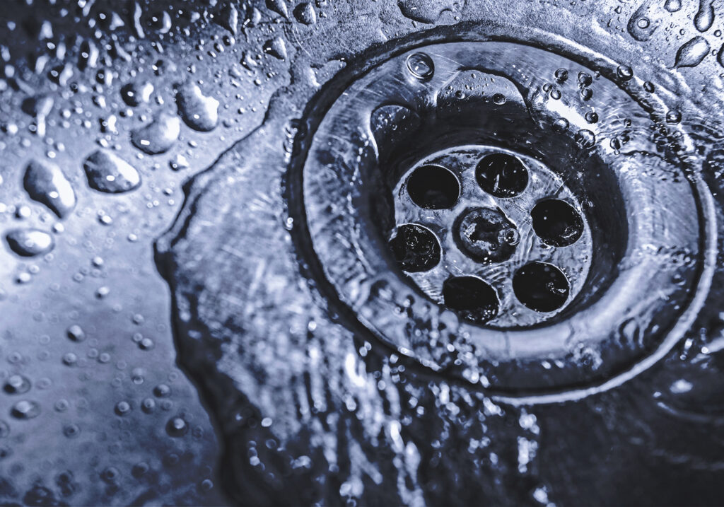 Image of a drain with water running. 